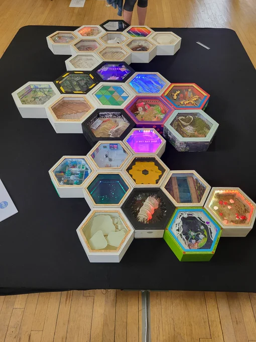 Hexagons of community Art: each cell by an individual local artist, lighting up with custom patterns. Made of silk, logo, wool, wood, paper.