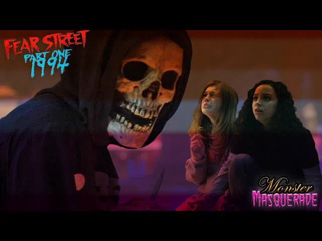 Thumbnail for Monster Masquerade. It features two teenagers hiding from a skull faced character. A lesbian flag is overlayed the graphic