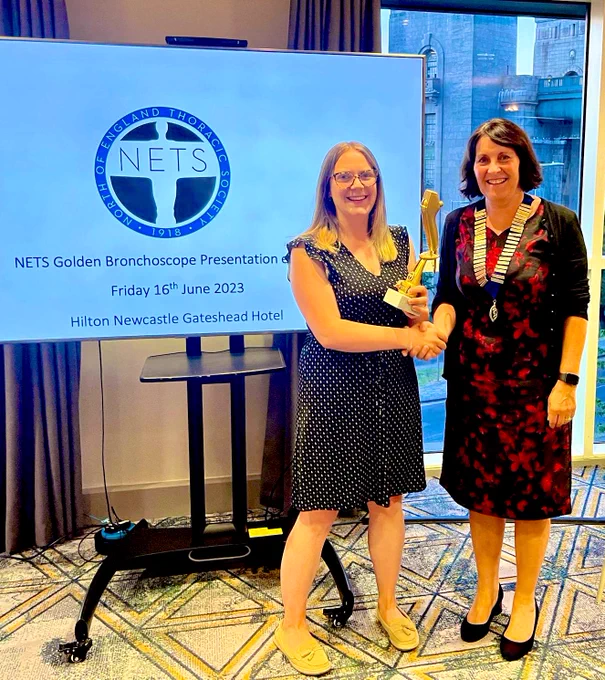 This is a picture of Dr Emily Harrison receiving the golden bronchoscope award from the NETS president Dr Karen Heslop-Marshall