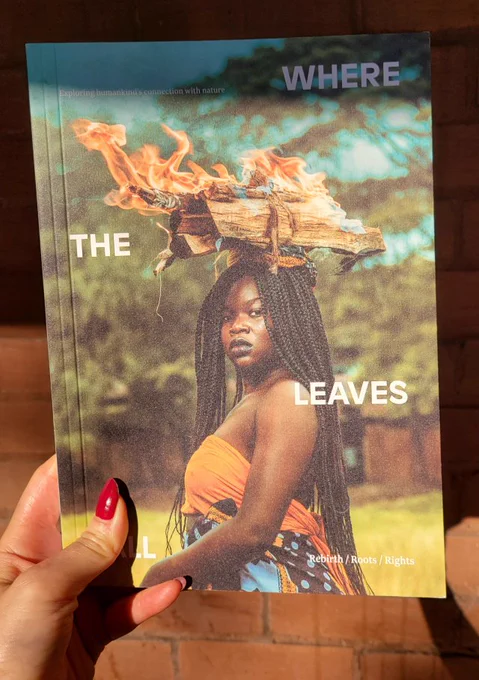 Hand holding copy of Where the Leaves Fall's Rebirth Roots Rights issues. Cover showcases a dramatic photograph of a Black woman with long braids and burning wood balanced on her head