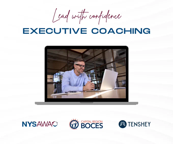 Red and blue text on a white background reads "Lead with confidence, Executive coaching" 

A person with dark glasses, brown hair and a blue shirt sits looks at their laptop 