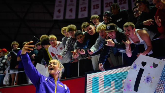 LSU gymnast Olivia Dunne takes a selfie with fans.