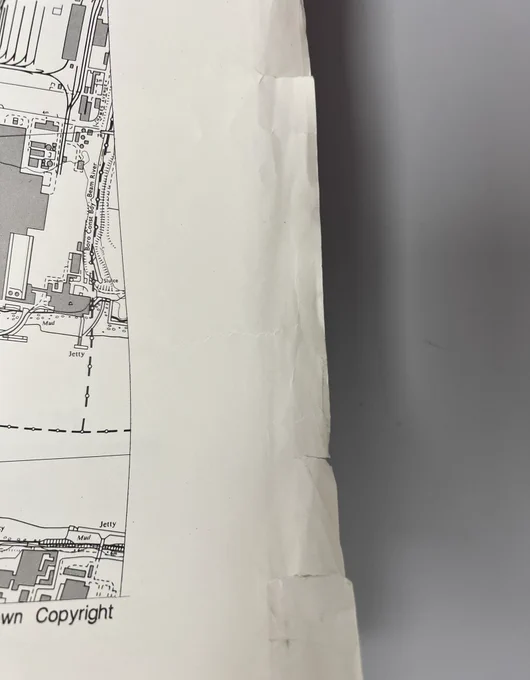 Creased and torn edges of a page of the collection item
