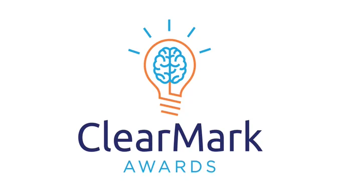 An orange outline of a lightbulb with blue design accents is seen on a white background. Text in blue font reads ClearMark Awards. 
