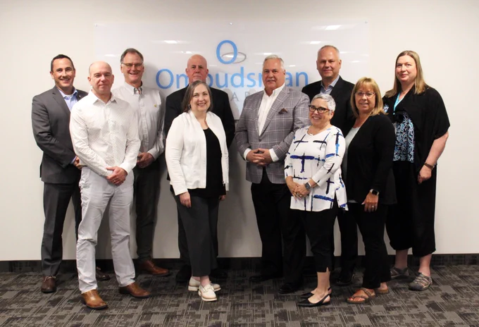 Group photo of ombudsman from across Canada, standing in front of the Ombudsman Ontario sign.