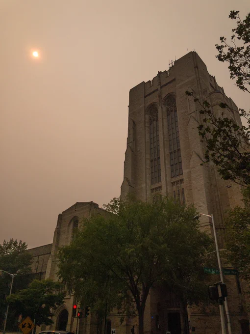 Photo of Yale’s Payne Whitney Gym with smoky haze covering the sun. Photo by Sam Rubin.