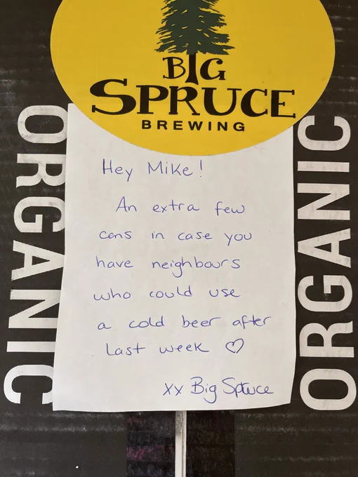 Box of Big Spruce Brewing with a note that reads, “Hey Mike! An extra few cans in case you have neighbours who could a use cold beer after last week. XX Big Spruce”