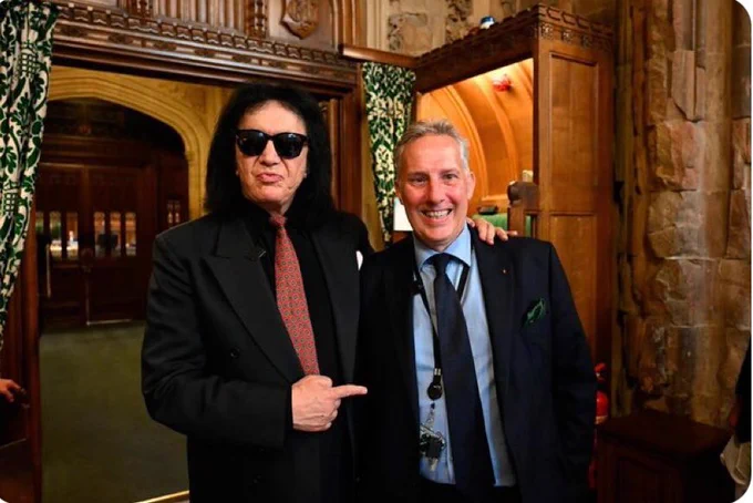 Kiss Singer Gene Simmons stands alongside Ian Paisley Jr. The text of the photo reads 'Gene Themmuns', a reference to the sectarian politics of the DUP.