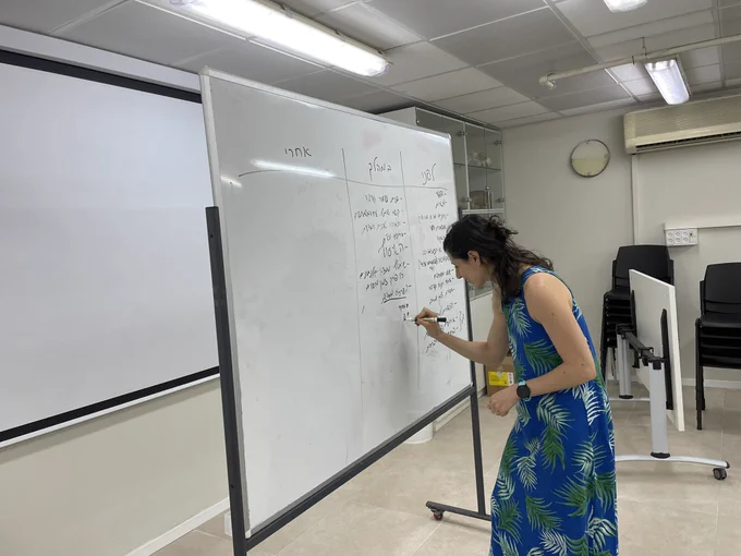 Women writing on a white board