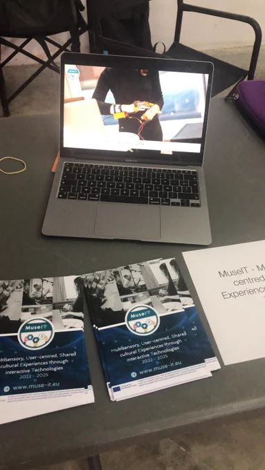 This is a picture of the MuseIT desk at the forum.
MuseIT flyers are in the foreground.
A computer with a video of haptic technologies is in the background.