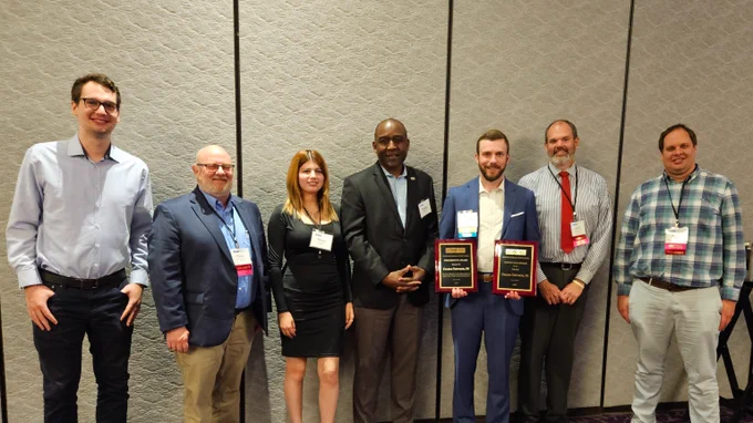 Attendees gather around to celebrate Charlie's awards.