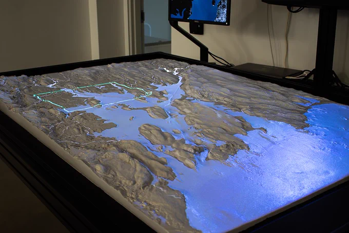 The installation depicts a physical, 3D model of Narragansett Bay's topography & bathymetry. Copeland and the creator team hope the Illuminated Bay will spur new ways of research and science visualization. Photo by Shaun Kirby