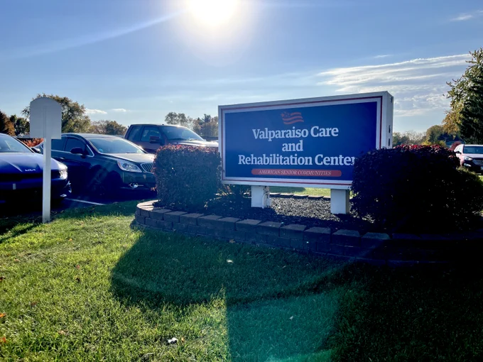 Blue, white, and red sign that reads, "Valparaiso Care and Rehabiliation Center." 