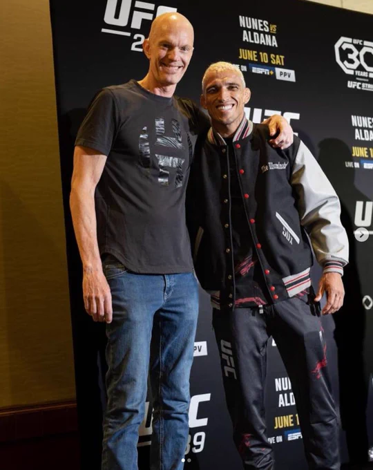 Charles Oliveira receives his 50x jacket.