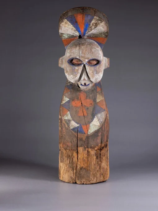 Image: a totemic (?) half-figure in carved, painted wood against a neutral grey photographic setting • "Unseeing Traces is a community project developed by IMMA in collaboration with New Communities Partnership (NCP), Ireland’s largest independent migrant-led national network. Inspired by a unique collection of hundreds of traditional artefacts inherited from the Kingdom of Kongo, by Nasser Aidara, NCP Community Development Coordinator, these artefacts will be exhibited at IMMA in dialogue with works from the IMMA Collection that rely on activation to uncover their cultural significance. The former Kingdom of Kongo (1300 – 1900s) was a large dominion covering present day Democratic Republic of Congo, Angola and the Congo Republic. The artefacts and artworks share a relational quality. Their meanings emerge from everyday rituals or special ceremonies – each carry a trace of past performances which can be re-activated through an encounter. Exploring displacement, colonialism, race and…"