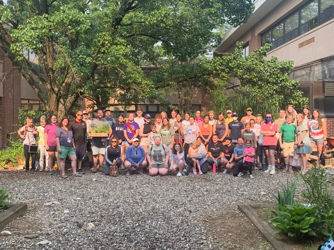 large group of people standing outside in a courtyard