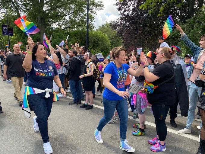 Photo of Gov. Healey and L.G. Driscoll marching in a pride parade