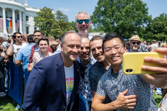 The Second Gentleman takes a photo with attendees at a Pride celebration.