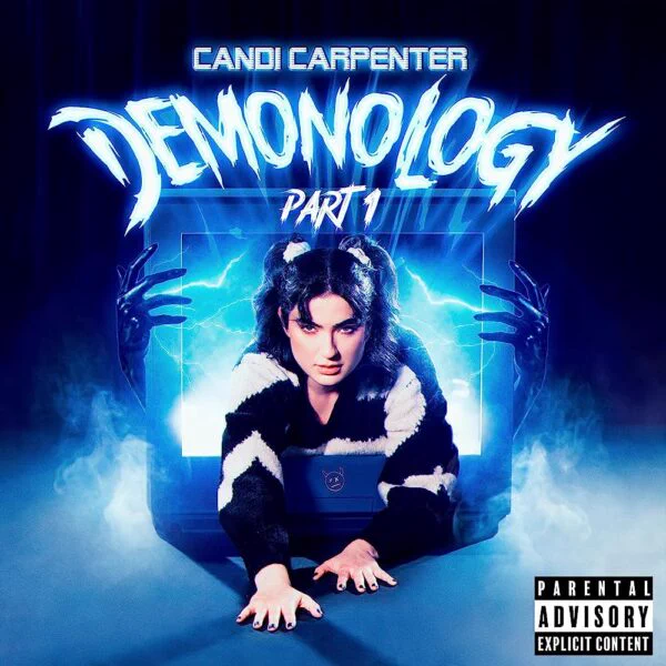 Candi Carpenter - Demonology Part I. Candi climbs out of a TV being held up by sinister hands, with smoke and lightening emerging from the television.