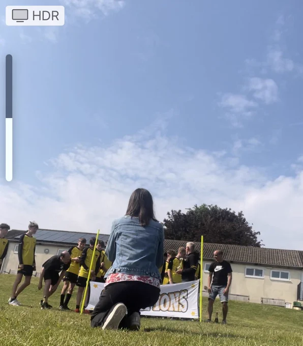 I’m photobombing my own video - you can’t see the football team behind a banner, just the back view of me.