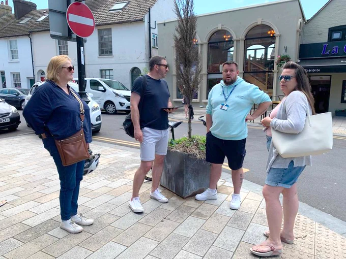 Group of people standing on street corner having conversation
