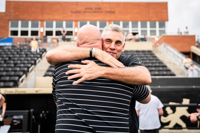 Head coach Steve Forbes embracing Wake baseball head coach Tom Walter