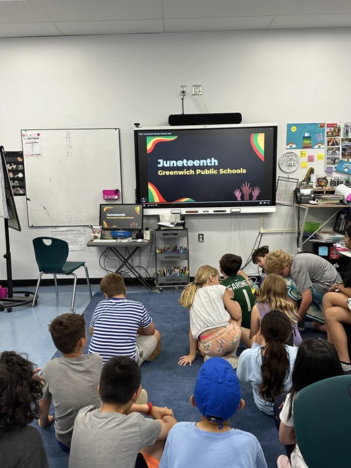 Fourth grade students watching a Juneteenth presentation. 