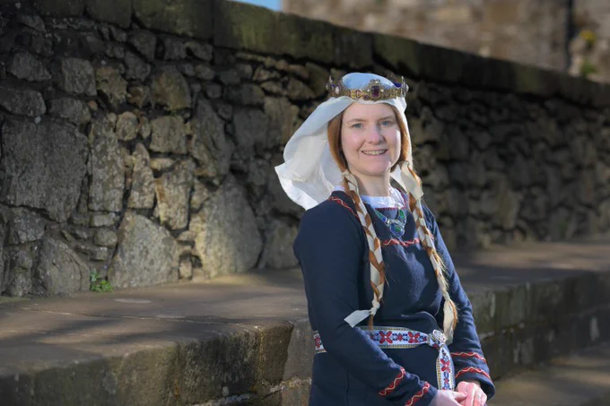 Smiling woman in medieval costume.