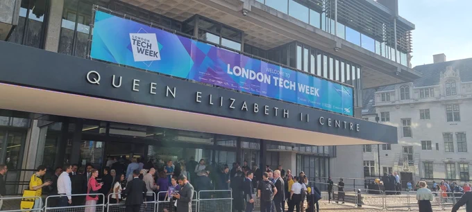 Inage shows a colour photograph of the Queen Elizabeth II Conference Centre, Broad Sanctuary,Westminster, London. The photo features crowds gathering to register for day 1 of the London Tech Week organised by Informa Media. Photo by Mike Hurst. Copyright. All rights reserved. Used with permission. 