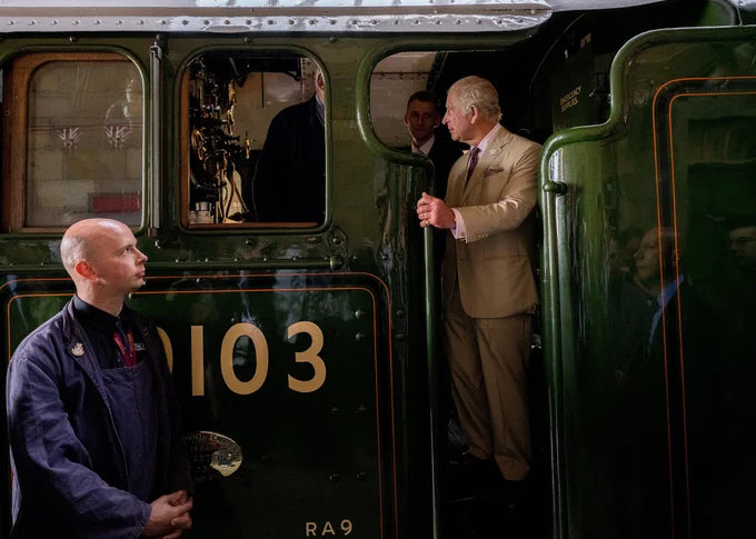 The King is pictured standing on the footplate of the Flying Scotsman