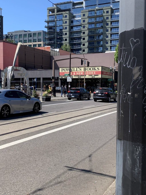 Photo of Powell’s Books Used and New with street on foreground