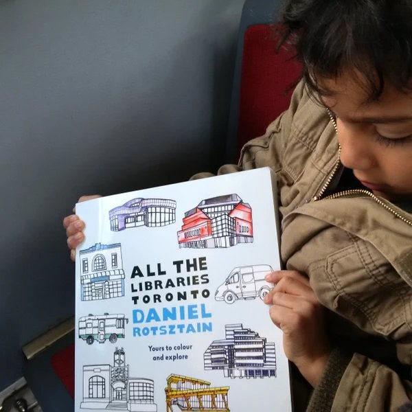 Little boy holding an adult colouring book