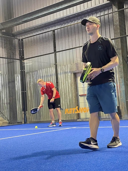Two people playing padel