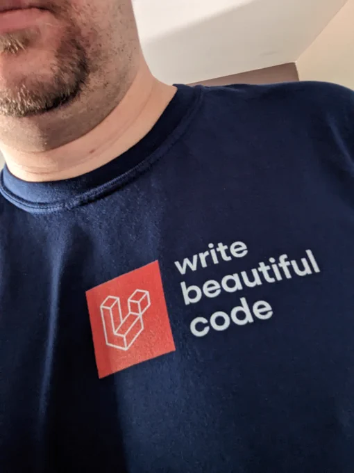 a t-shirt with the Laravel logo and the words, Write Beautiful Code