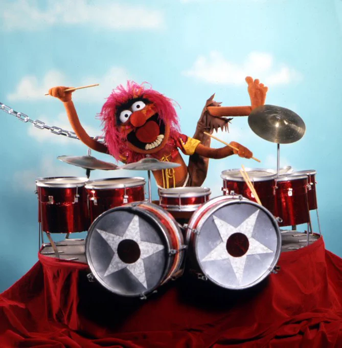 Animal from The Muppets playing the drums
