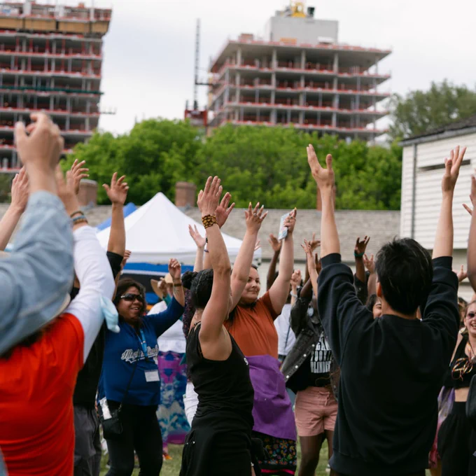 People dancing outdoors at Indigenous Arts Festival 2022.