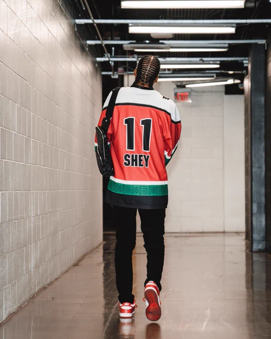 Shey Peddy showcasing the back of her custom Riveters jersey