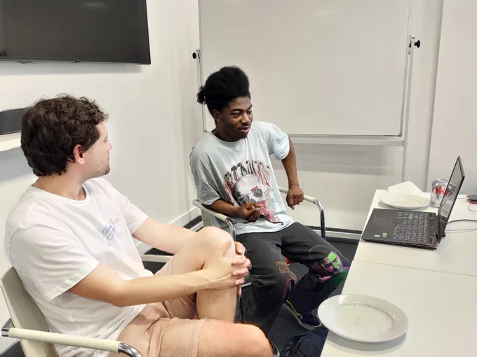 young black student explaining his code to his coach