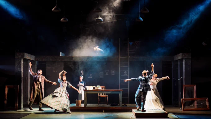 A group of actors dancing on stage.