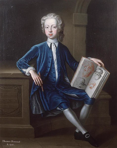 A portrait of Thomas Pennant as a boy, dated c. 1740, wearing a blue suit and holding a book of sketches.  Attributed to Joseph Highmore (1692–1780), and  held by Llyfrgell Genedlaethol Cymru / The National Library of Wales.
