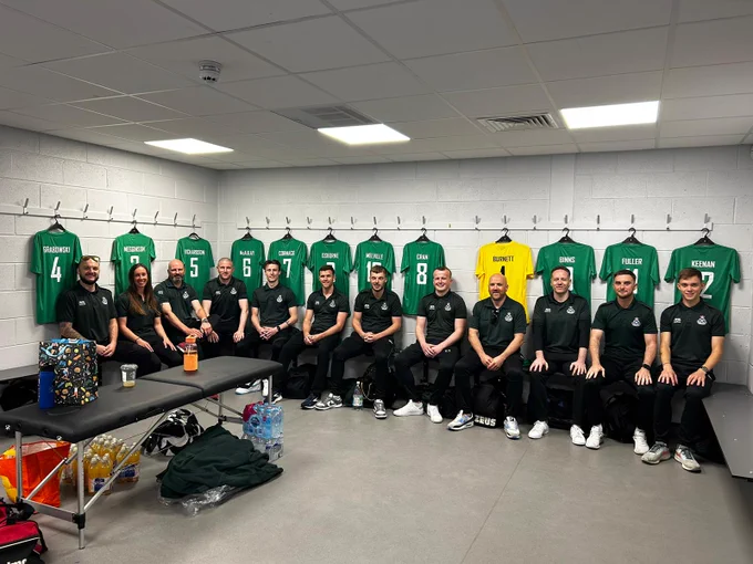 SAS football team inside the football grounds with their shirts