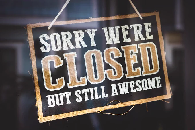 Sign hanging on a shop door reading: Sorry we're closed but still awesome.