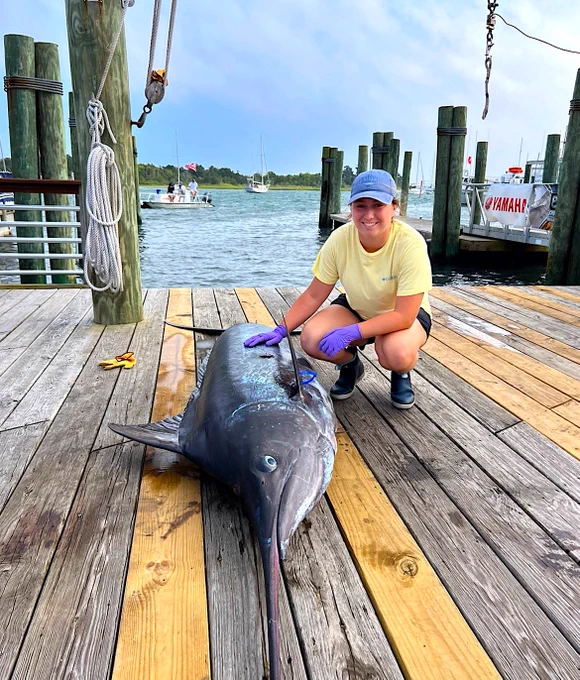 Sarah Smith with a blue marlin on the Morehead City waterfront, before it leaves the dock for CMAST. 