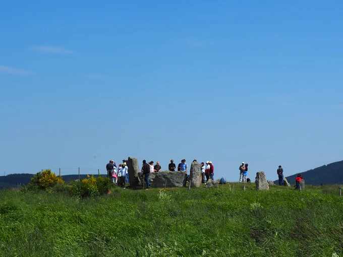 Group of people standing next to a stone circle