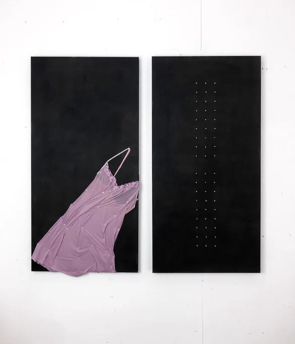Artwork by Ayse Kipri shows a pink nightdress flattened out on one of two canvases painted black with oil painted and rivets in them.