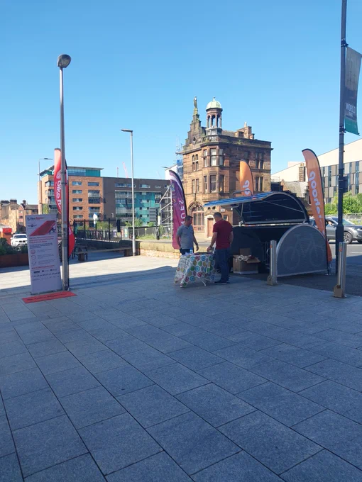 Image of bike register banner and cycle pod within Glasgow city centre