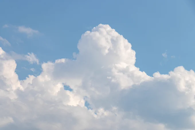 Photograph of clouds in a blue sky. 
