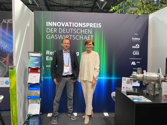 Thomas Wencker und Ministerin Stark-Watzinger stehen auf dem Stand des Innovationspreis 2022 beim BDEW-Kongress 2023.