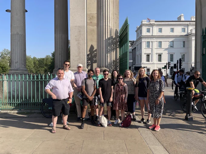 Legal team pose for a photo during the London Legal Walk in front of a white building and pillars