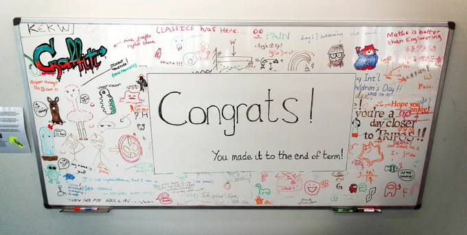 Graffiti board for students with colourful drawings and a message of congratulations